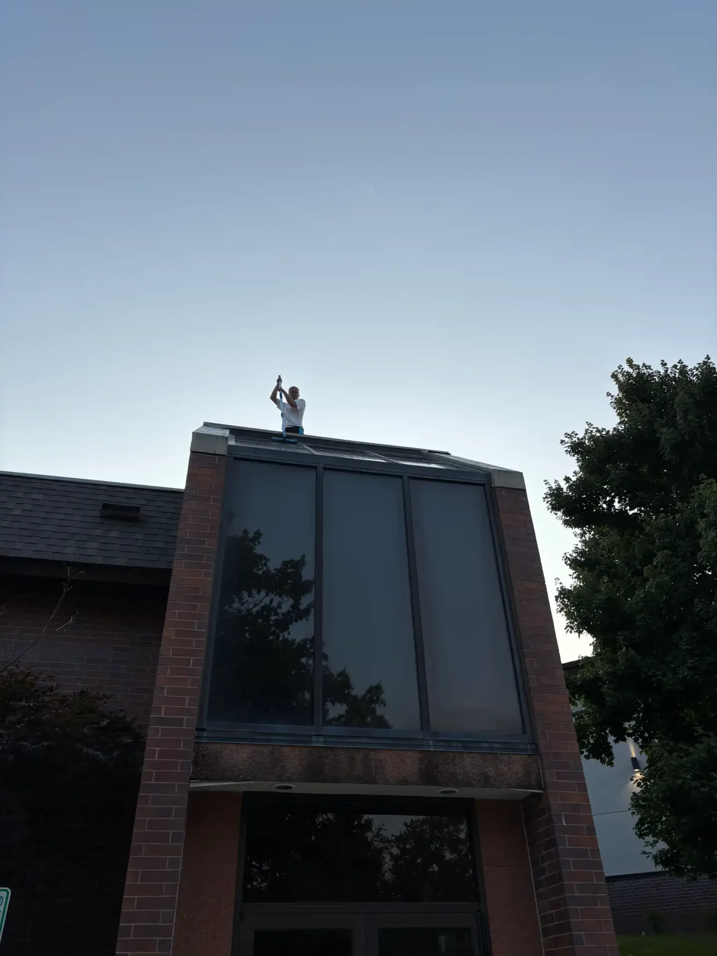 Skylight on a residential roof being cleaned
